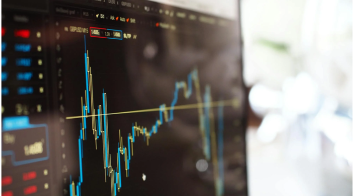 Person analyzing trading charts and account options on a laptop